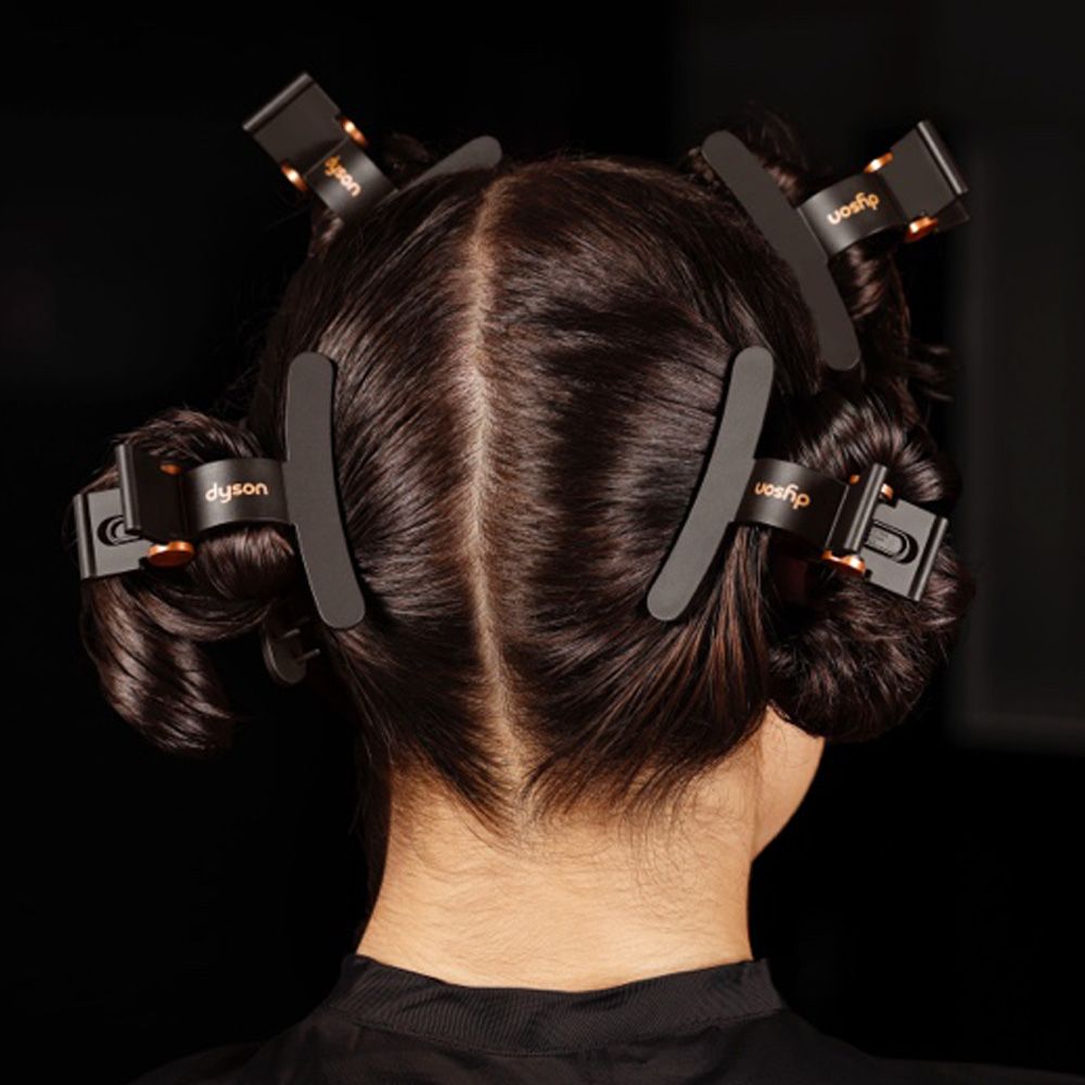 Dyson hair clips are used to section a model’s hair ready for styling.