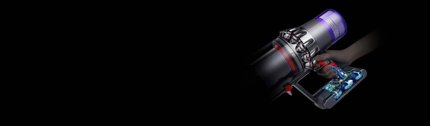 The trigger being pressed on a Dyson V11™ vacuum with the battery showing.